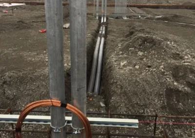 A construction site with a lot of pipes and wires.