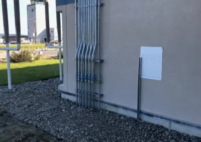 The outside of a building with metal pipes on it.