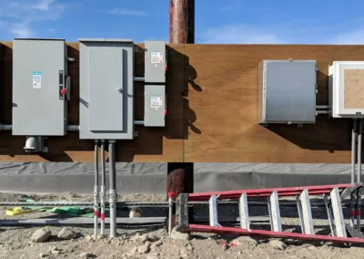 A group of electrical boxes on the side of a building.