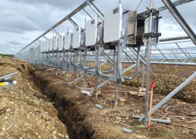 A group of solar panels in a field.