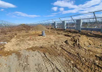 The construction of a solar farm in a field.